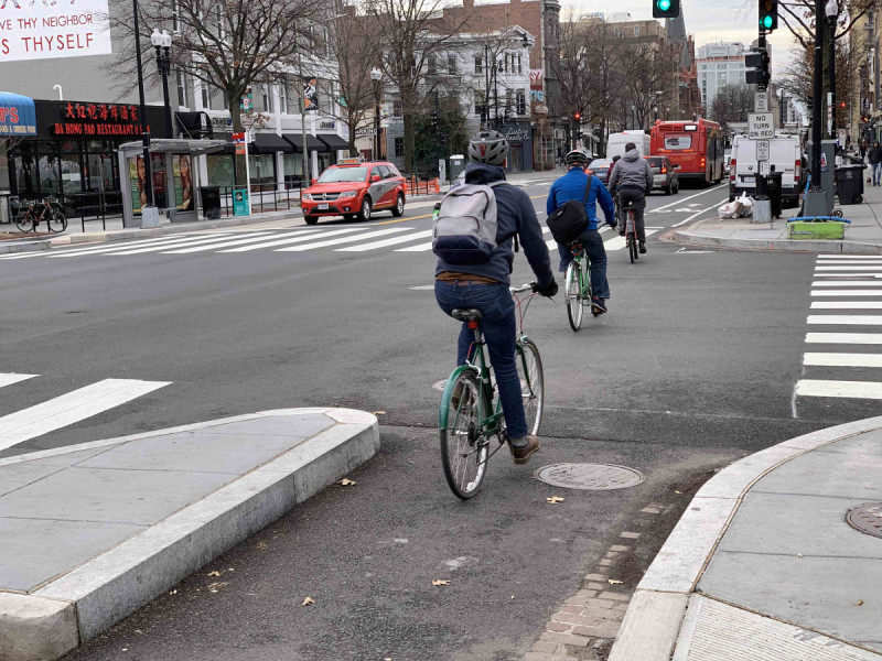 bikers bike down 14th street nw in washington dc